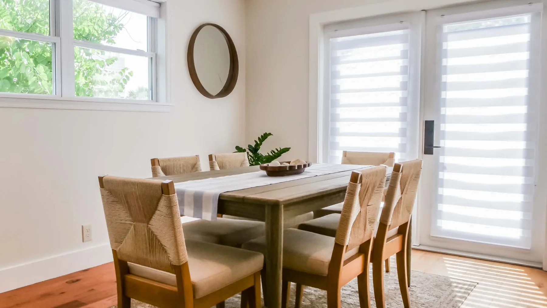 Dining table beside white shutters
